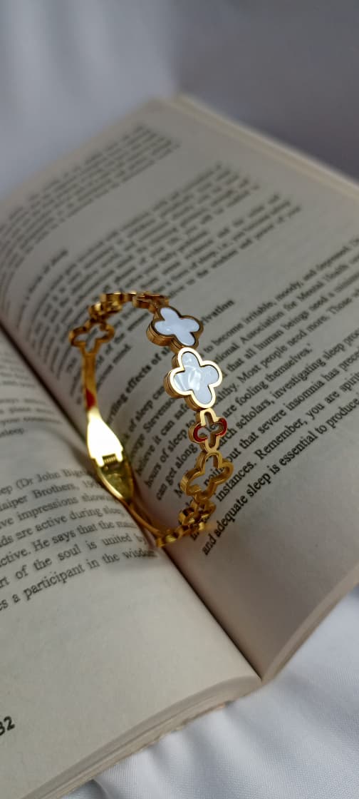gold clover bracelet, enamel jewelry, lucky charm bracelet, elegant women’s bracelet, chic fashion accessories, timeless jewelry, white and gold bracelet, fashion bangle, stylish wristwear, everyday jewelry, luxury bracelet, gift for her, trendy accessories